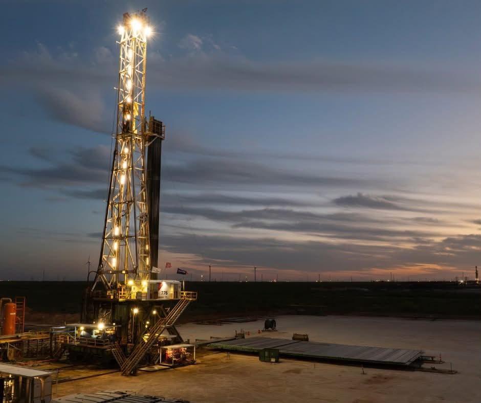 Contract drilling rig at sunset